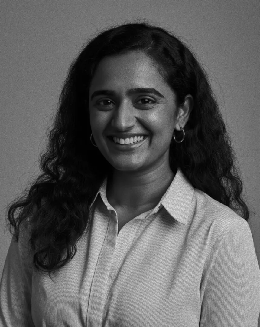 A confident woman smiling in a professional black-and-white portrait, representing authentic leadership and the alignment between organizational culture and brand aspiration.